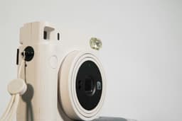 A white film camera with large lens
